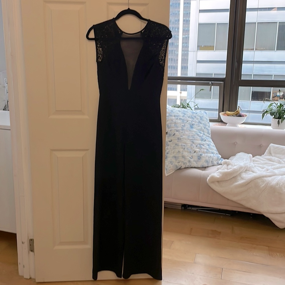 Size 2-4 black pantsuit. Lace cutout to show cleavage